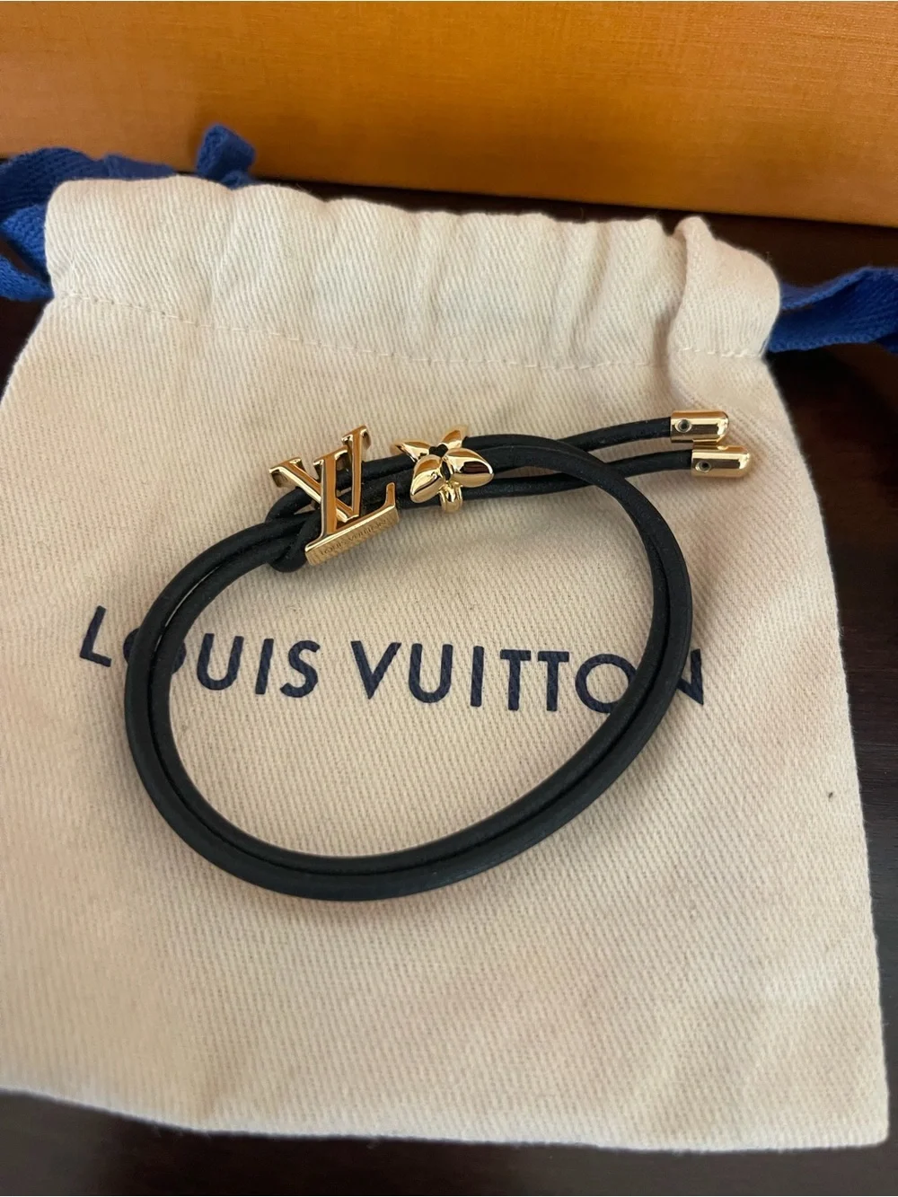 Louis Vuitton Blossom Black Cord Bracelet with Gold LV and Flower. Adjustable.